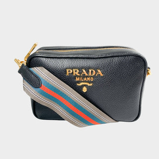 Prada camera bag in black leather with gold hardware and webstrap