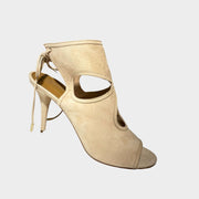 Side profile of Aquazzura Sexy Thing 85 sandals in beige suede, featuring teardrop cut-outs, an open toe, and an 85mm stiletto heel.