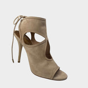 Side profile of Aquazzura Sexy Thing 105 sandals in beige suede, featuring teardrop cut-outs, an open toe, and ankle tie closures.