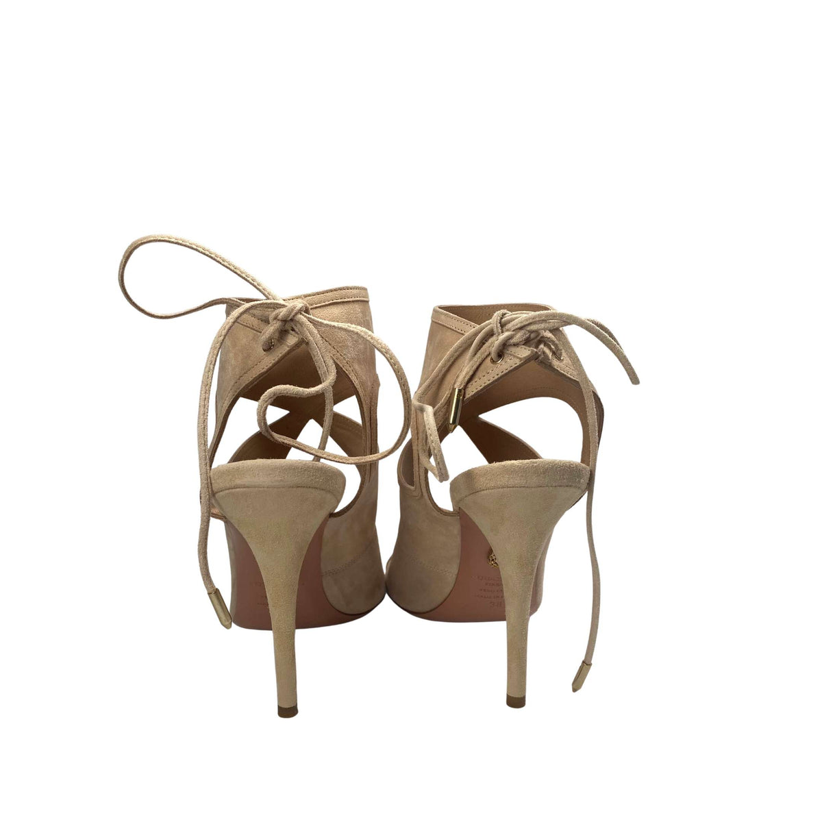 Heel side angle of an Aquazzura Sexy Thing 105 nude suede pump, highlighting the 105mm stiletto heel and elegant ankle tie back.
