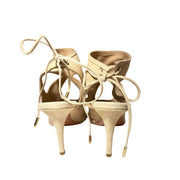 Heel view of Aquazzura Sexy Thing 85 beige suede sandals from behind, focusing on the rear ankle tie closures and slim 85mm heel profile.