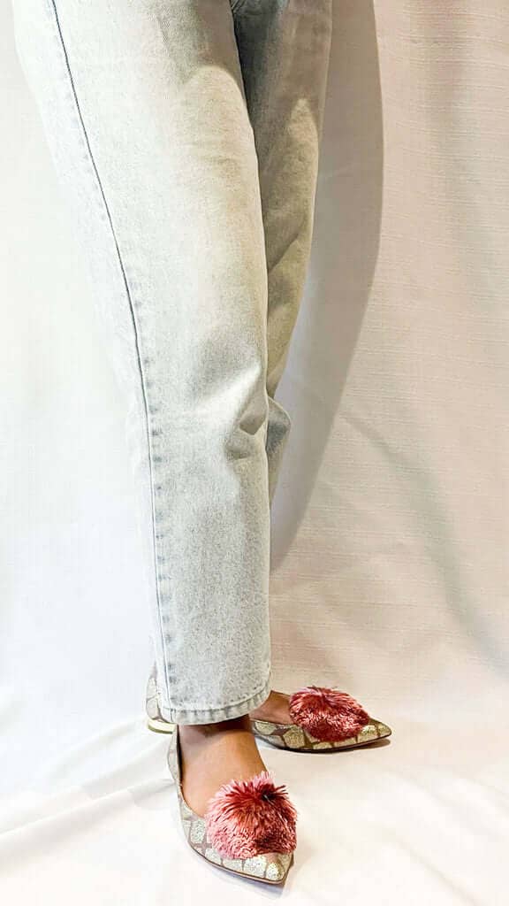 On-foot wearing view of Aquazzura limited edition Lucky Lotus Powder Puff ballerina flats styled with casual denim jeans.