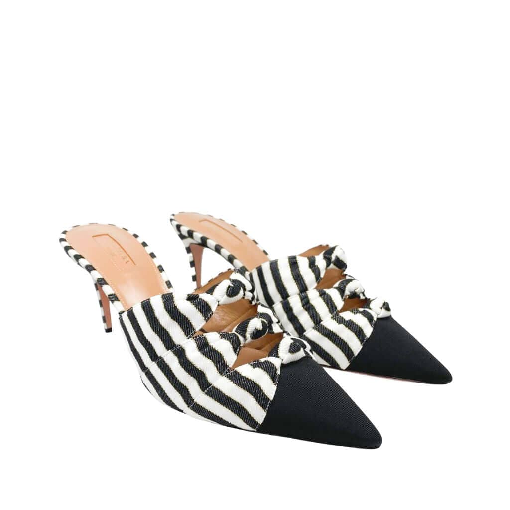 Side profile of Aquazzura Mondaine mule heels in black and white striped faille fabric, showing the 75mm stiletto heel and pointed toe