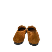 Heel view of Aquazzura Wild Thing brown suede loafers, showing the smooth low block heel and the embossed logo branding on the leather outsole.