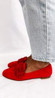 Side angle wearing shot of the Aquazzura Wild Thing red suede loafer flat, highlighting the low block heel and slip-on silhouette.