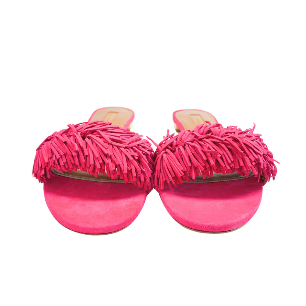 Symmetrical front angle of pink suede Aquazzura Wild Thing flat sandals against a white background.