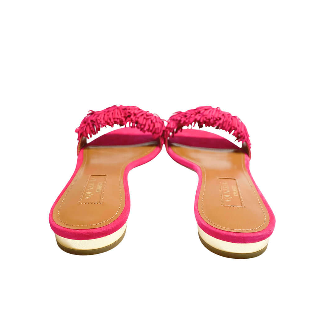 Heel view of Aquazzura Wild Thing pink suede sandals from behind, focusing on the metallic mirrored heel accent and clean rear construction.