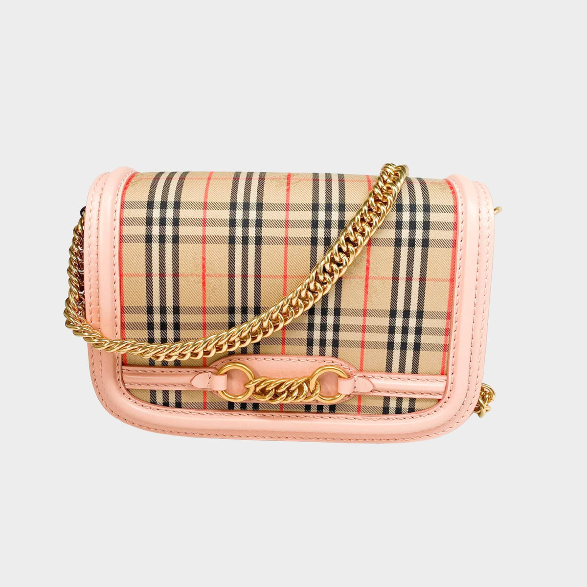 Front view of the Burberry Link shoulder bag featuring beige house check canvas and elegant peach patent leather trim.