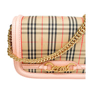 Detailed close-up of the front flap on the Burberry Link bag, showcasing the signature gold-tone chain link embellishment.