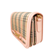 Side profile view of the peach leather and canvas Burberry Link bag, showcasing its structured depth and gold chain details.