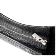 Close-up of the silver-tone metal zipper closure and pull tab on the black leather Burberry Chess bag.
