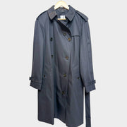 Front view of the classic Burberry Hillington trench coat in black lightweight cotton gabardine on a wooden hanger.
