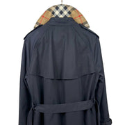 Close-up rear view of the Burberry Hillington black trench coat showcasing the iconic vintage check undercollar detail.