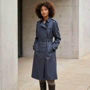 Full-length view of a model wearing the tailored black Burberry Hillington trench coat, showcasing its modern elegant fit.
