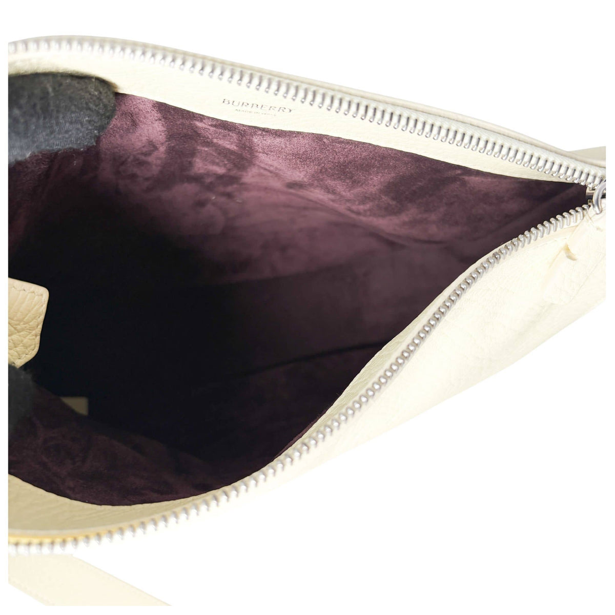 Interior compartment view of the lime yellow Burberry Knight leather bag, showing the dark purple lining and spacious layout.