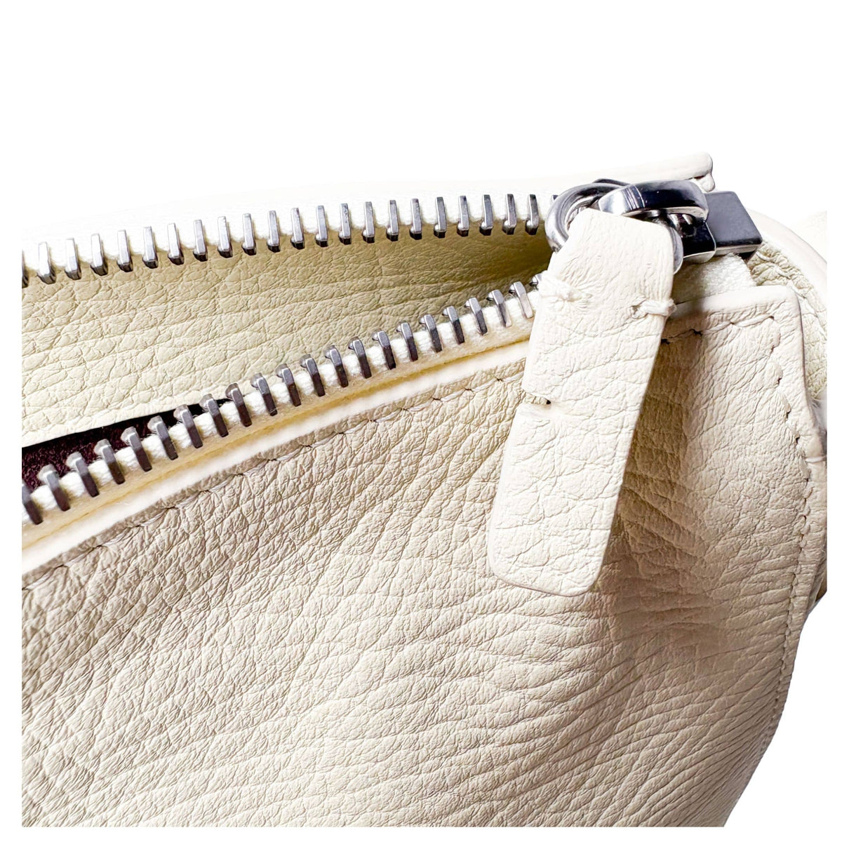 Close-up of the wide adjustable leather strap and polished silver-tone buckle on the Burberry Knight bag.