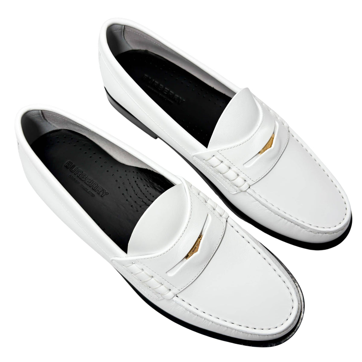 Parallel studio arrangement of both white Burberry Rupert Coin Loafers placed side-by-side against a crisp background.
