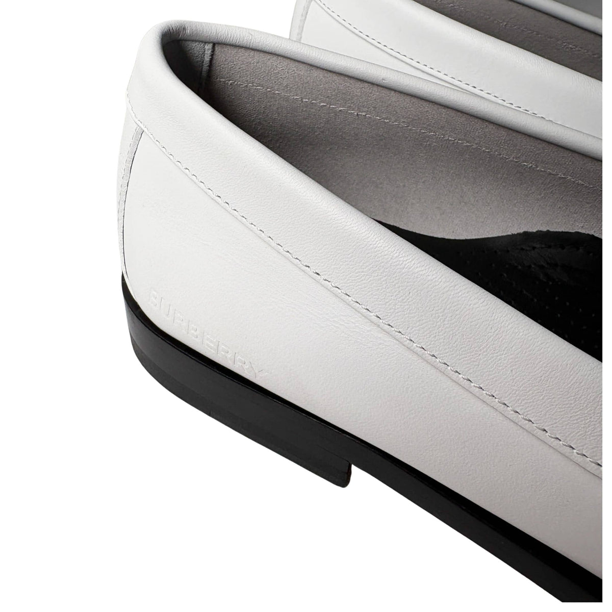Close-up detail shot of the meticulous topstitching along the apron toe of the white leather Burberry Rupert loafer.