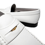 Asymmetrical studio layout of the white leather Burberry Rupert Coin Loafers, with one shoe angled forward to display the side profile.