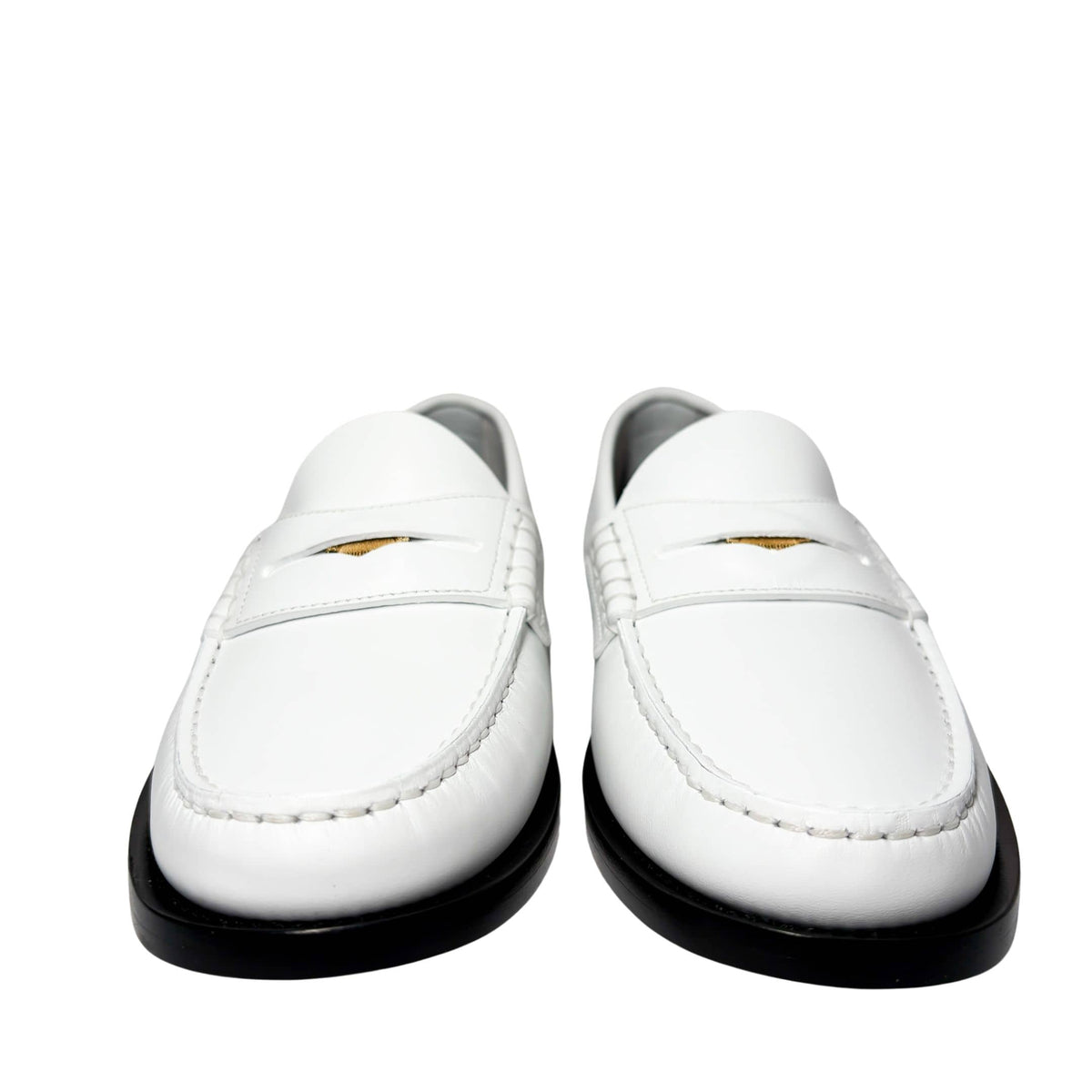Three-quarter studio profile of the white Burberry Rupert Coin Loafers, showing the elegant lines and polished leather finish.