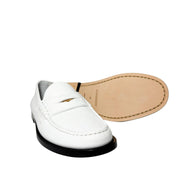 Overhead top-down view of a pair of white leather Burberry Rupert Coin Loafers, showing the neat stitching and interior branding.