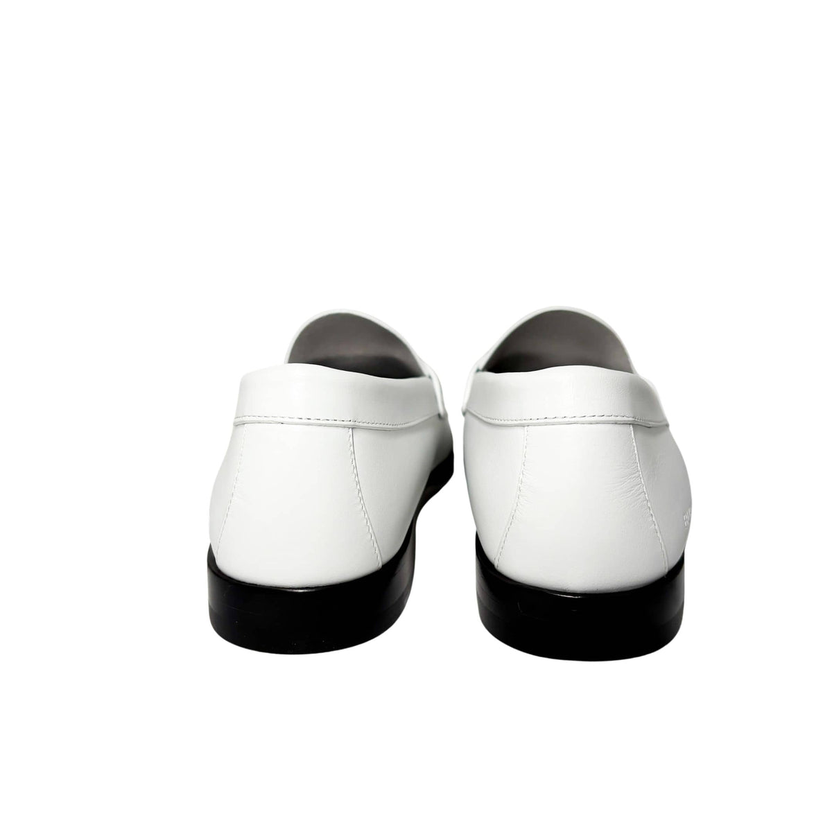 Authentic white leather Burberry Rupert Coin Loafers displayed next to their luxury designer product box and protective dust bag.