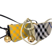 Close-up view of the black leather strap attachments and refined stitching on the checkered Burberry Shield bag.