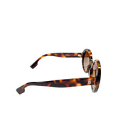 Three-quarter angled view of Burberry tortoiseshell sunglasses showing the curved frame shape and slender temple arm.