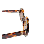 Side profile view of Burberry round sunglasses showcasing the tortoiseshell acetate temple arm and hinge design.