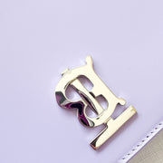Close-up view of the iconic silver-tone Thomas Burberry (TB) monogram clasp on the lilac leather shoulder bag.