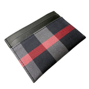 Three-quarter angled studio shot of Burberry House Check leather card holder highlighting the slim, compact profile and central pocket.