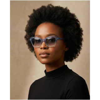 Model wearing Burberry blue and silver sparkly sunglasses styled as a statement luxury accessory