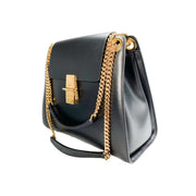 Three-quarter side profile of the black Chloé Annie bag, displaying its spacious gusseted side structure and gold-toned hardware