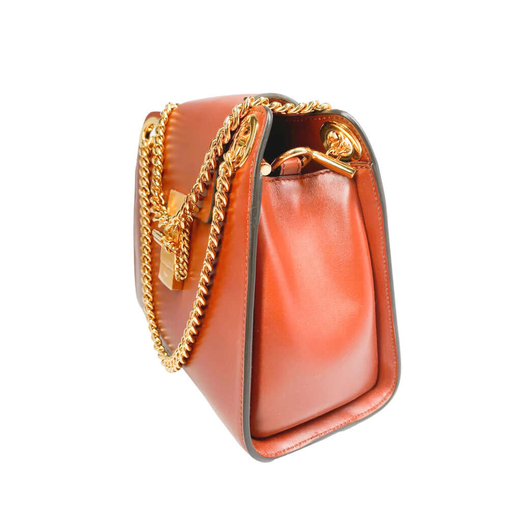 Three-quarter angle view of the Chloé Annie shoulder bag in warm tan leather, displaying its structured silhouette and spacious side depth.