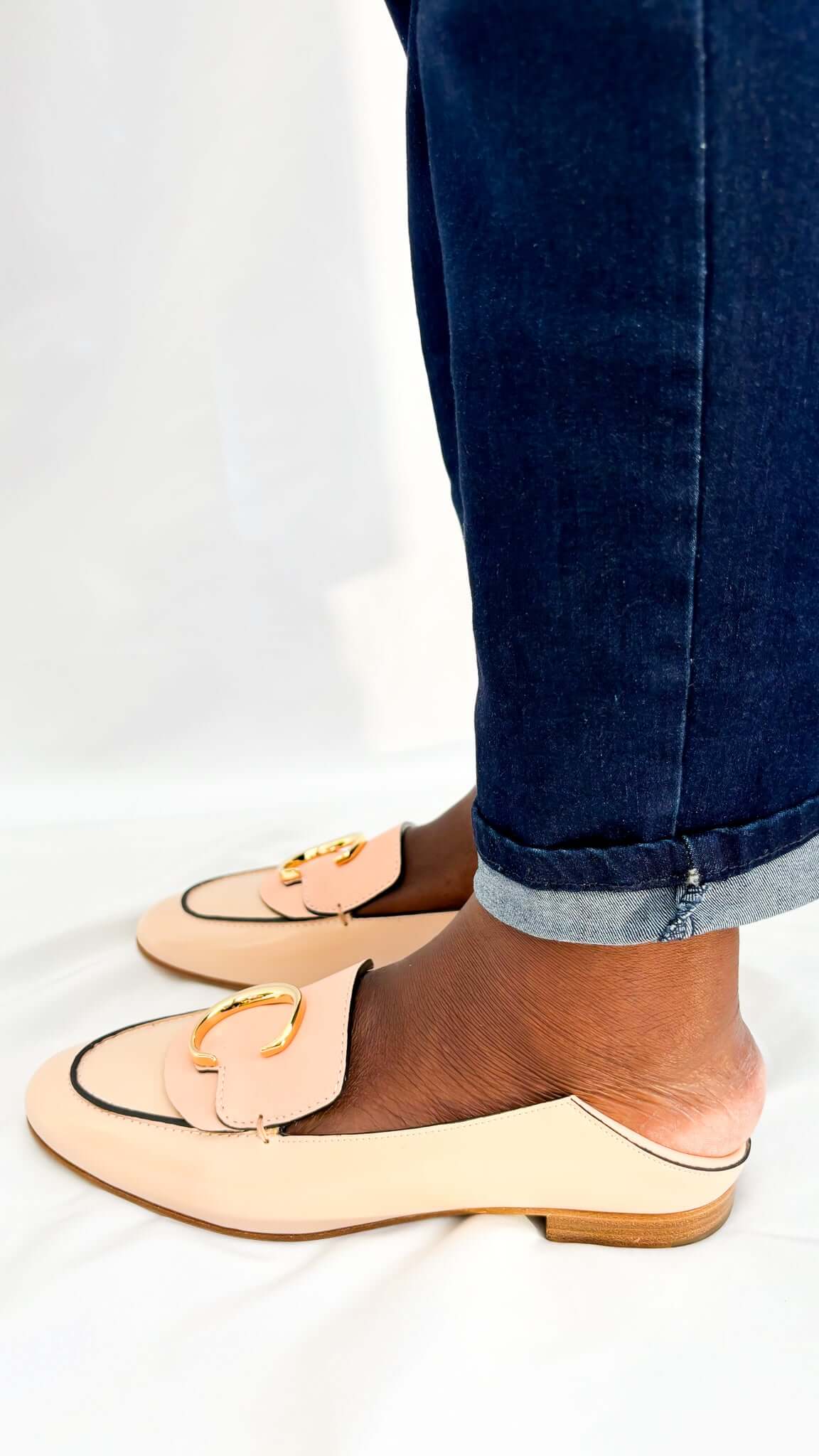 Rear view of a pair of Chloé C pink patent leather loafers from behind, showing the clean stitching and convertible heel counter structure.