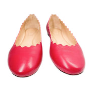 Side angle studio shot of a pair of Chloé Lauren scalloped ballet flats in raspberry sorbet pink leather.