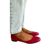 On-foot side profile view of the Chloé Lauren scalloped ballet flats in deep pink leather, highlighting the comfortable flat sole construction.
