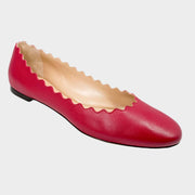 Side profile close-up of a Chloé Lauren ballet flat in raspberry sorbet pink leather, showcasing the iconic scalloped edging and round toe.