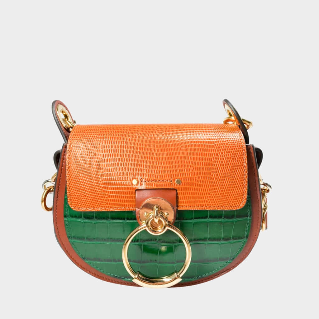 Front close-up view of the Chloé Tess Bag in brown and green croc-embossed leather, showcasing the prominent gold and silver-toned ring hardware.