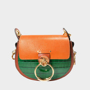 Front close-up view of the Chloé Tess Bag in brown and green croc-embossed leather, showcasing the prominent gold and silver-toned ring hardware.