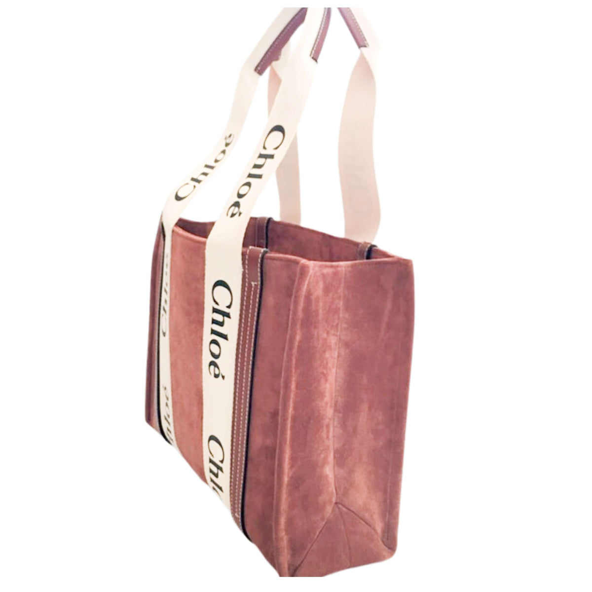 Side studio view of the Chloé Woody medium tote bag in brown suede against a white background, showcasing its spacious rectangular silhouette.