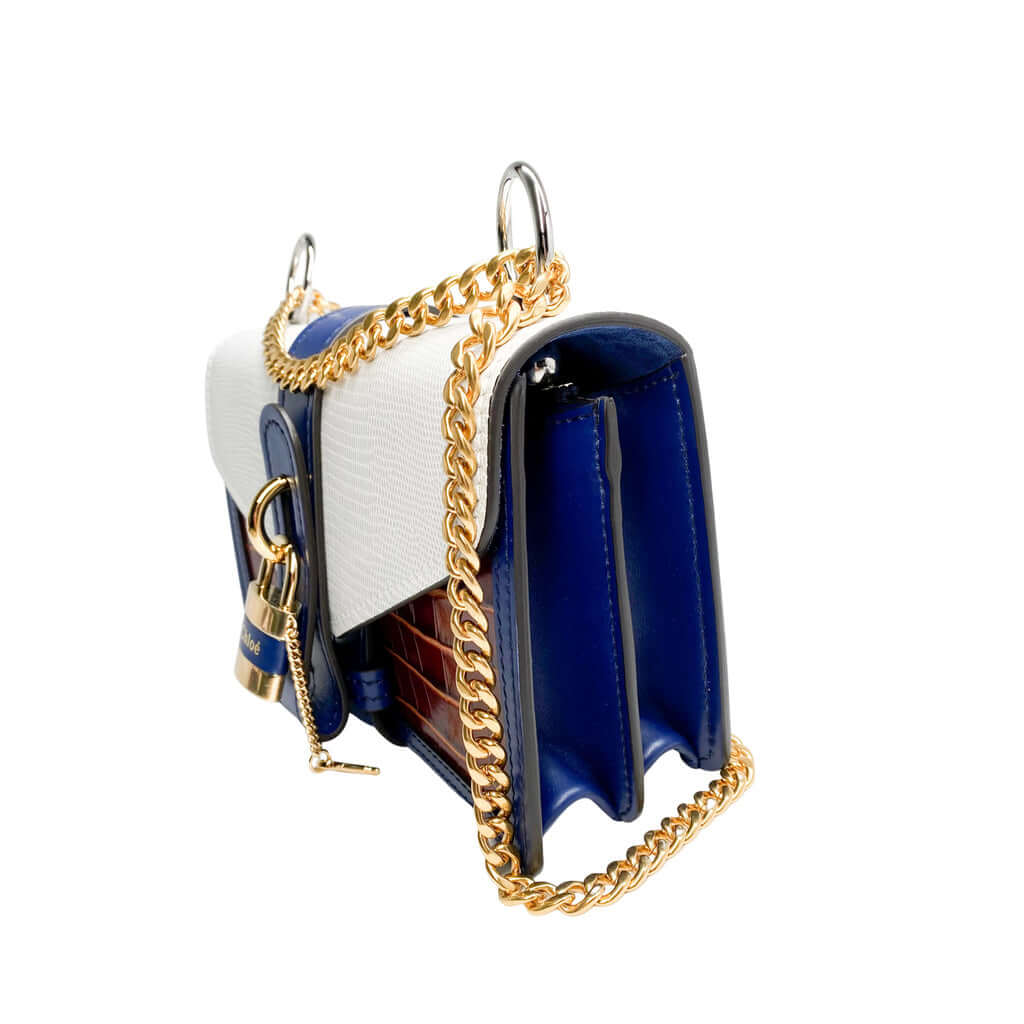 Side profile view of the tri-color Chloé Aby Day Chain bag, showcasing its structured accordion-style depth and blue side panels.