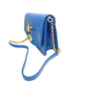 Right side three-quarter profile of the blue Chloé C shoulder bag, showing the structured base, leather shoulder strap, and polished gold-tone hardware.