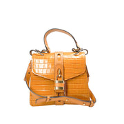 Front studio view of the Chloé Aby Day Ocre brown croc-embossed shoulder bag against a white background, featuring the structured silhouette and handle.