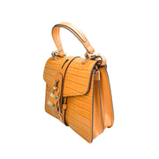 Right side three-quarter profile of the Chloé Aby Day brown leather bag, highlighting its softened structural angles and embossed texture details.