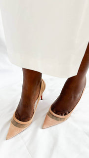 Top-down perspective wearing shot of a pair of dusky pink suede Christian Louboutin Galativi 90 pumps.