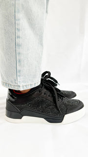 Side-angle view of the Christian Louboutin Aurelien trainer on-foot, highlighting the low-top silhouette and the clean white textured midsole line.