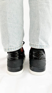 Rear view of the black Christian Louboutin Aurelien sneakers from behind on-foot, showcasing the padded heel counter and structured collar.