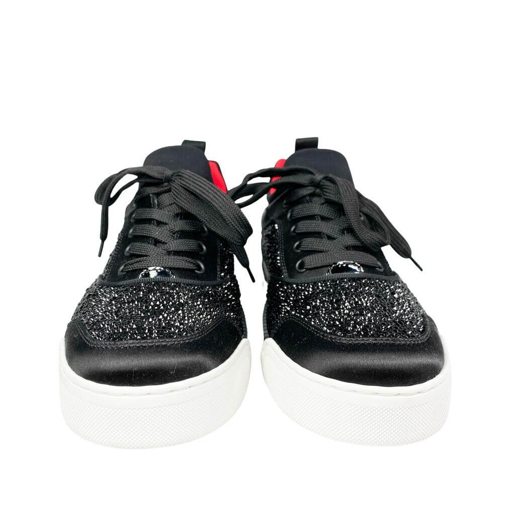 Flat lay shot focusing on the textured white midsole and debossed signature red rubber outsole of the Christian Louboutin Aurelien shoe.