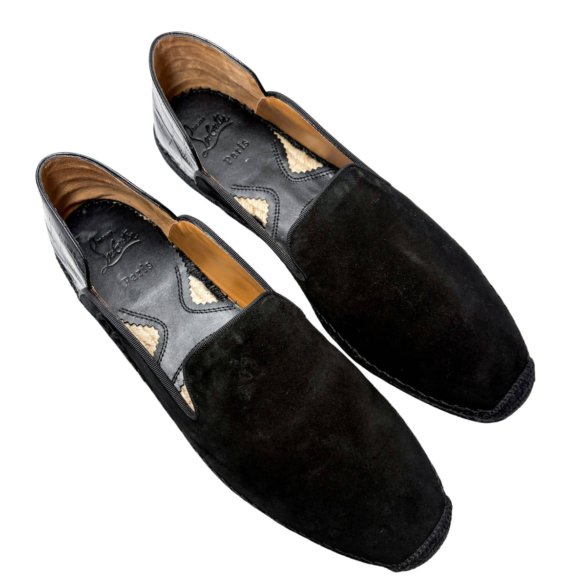 Top-down perspective shot of a pair of Christian Louboutin Varsi Espadon black suede espadrilles, showcasing the casual slip-on silhouette and tan leather interior lining